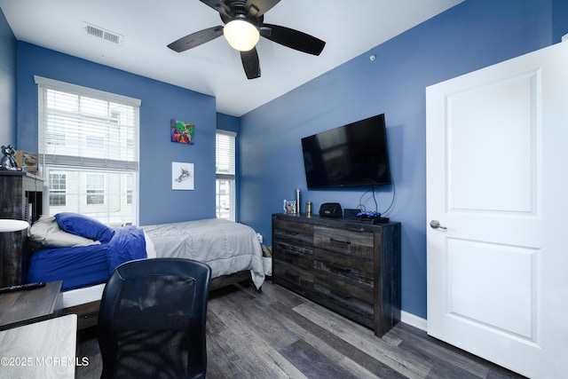 bedroom with ceiling fan and dark hardwood / wood-style flooring