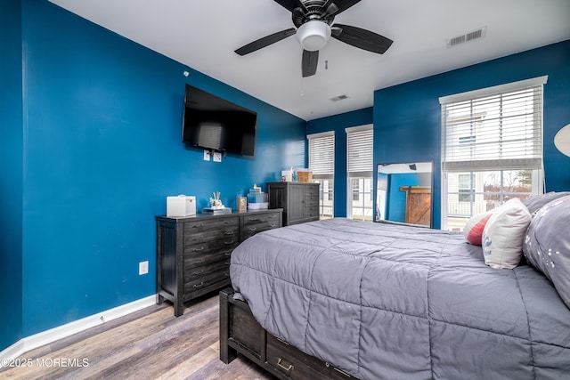 bedroom with light hardwood / wood-style flooring and ceiling fan