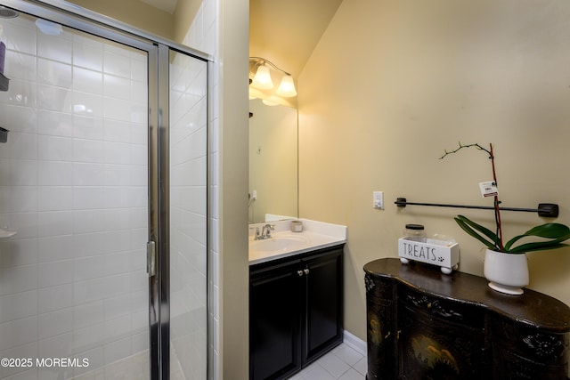 bathroom with vanity, a shower with door, and tile patterned flooring