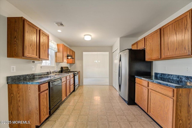 kitchen with sink, a notable chandelier, black appliances, and dark stone counters