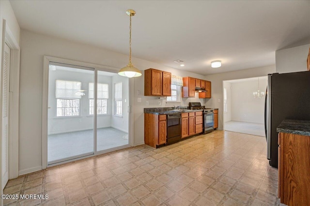 kitchen featuring hanging light fixtures, sink, a chandelier, and black appliances