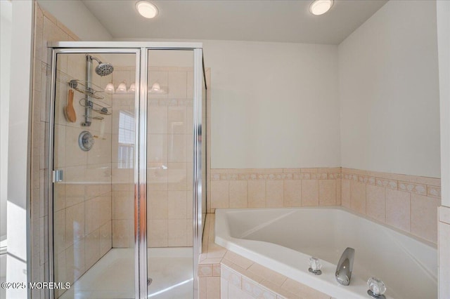 bathroom with separate shower and tub