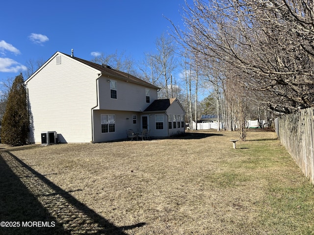 rear view of property with a lawn