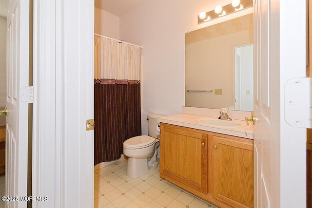 bathroom with vanity, walk in shower, and toilet