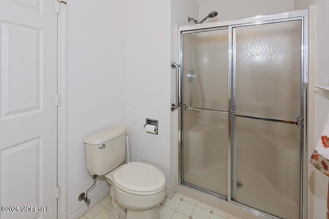 bathroom with toilet and a shower with shower door