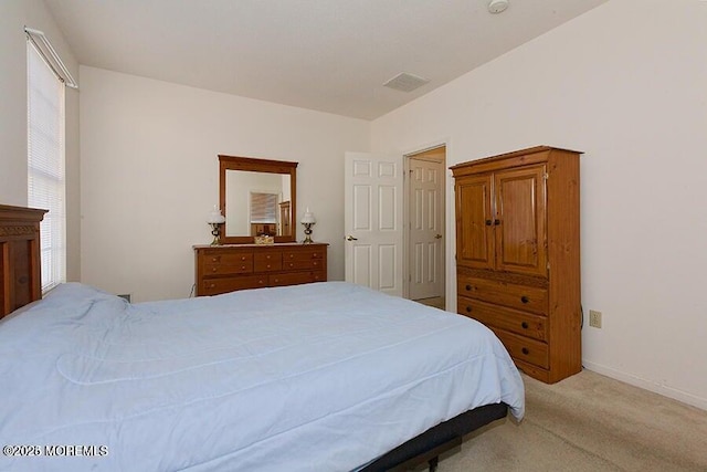 bedroom featuring light carpet