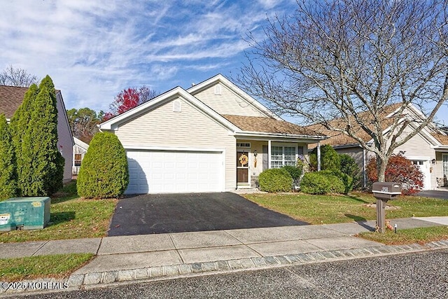 view of front of property with a garage and a front lawn