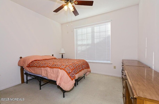 bedroom featuring light colored carpet and ceiling fan