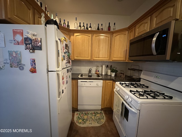 kitchen featuring sink, white appliances, and decorative backsplash