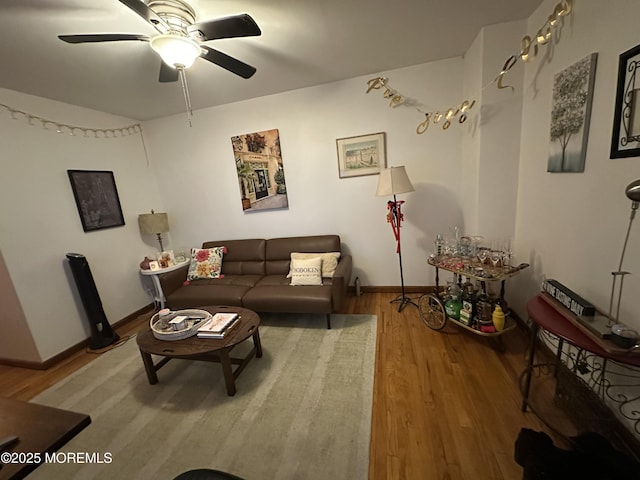 living room featuring hardwood / wood-style floors and ceiling fan