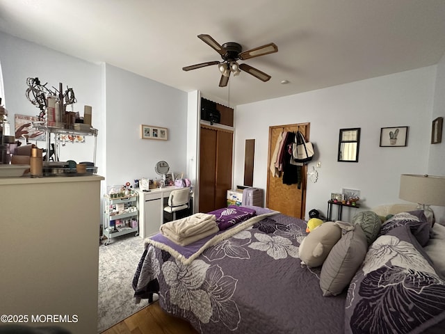 bedroom featuring wood-type flooring, a closet, and ceiling fan