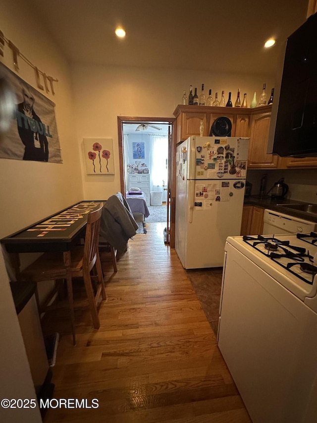 kitchen featuring dark hardwood / wood-style flooring and white appliances