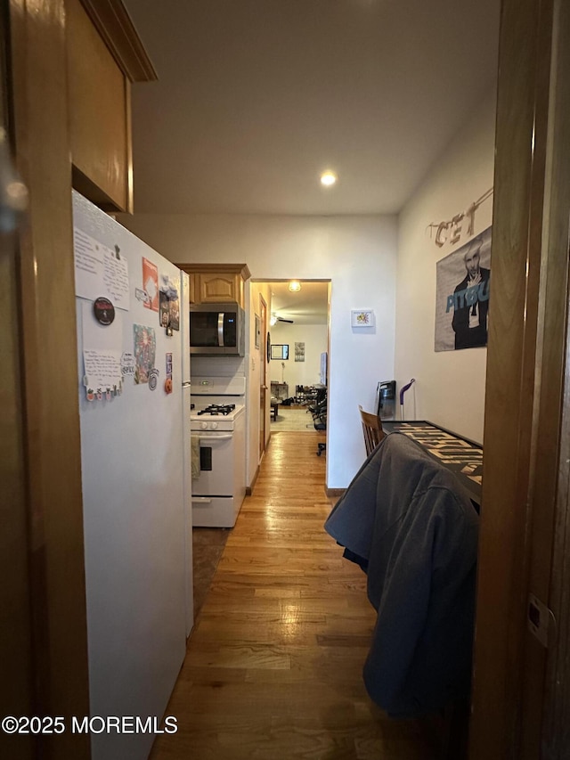 interior space featuring white appliances and light hardwood / wood-style floors