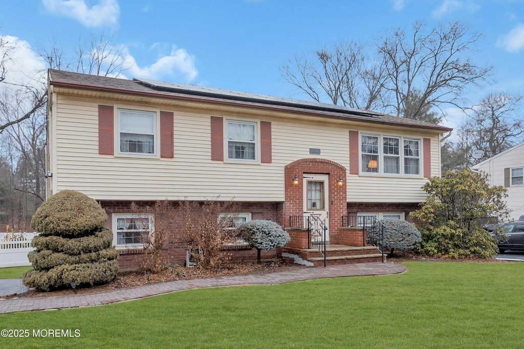 raised ranch with a front lawn