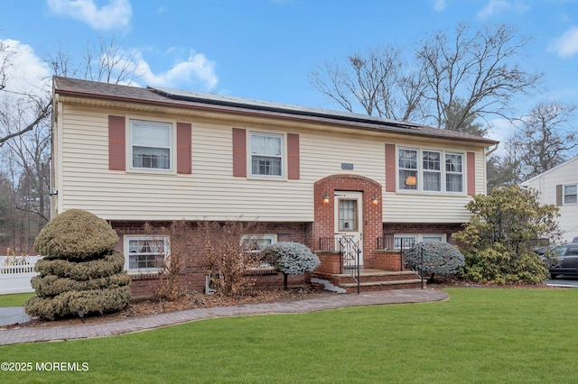 raised ranch with a front lawn