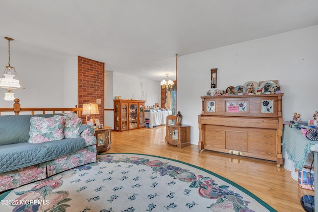 living room featuring an inviting chandelier and hardwood / wood-style flooring