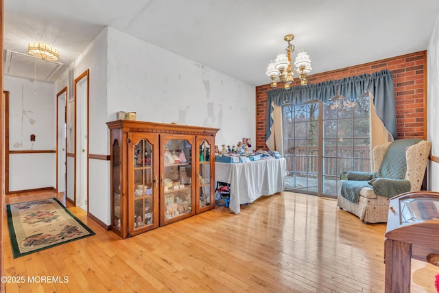 interior space featuring an inviting chandelier and light hardwood / wood-style flooring