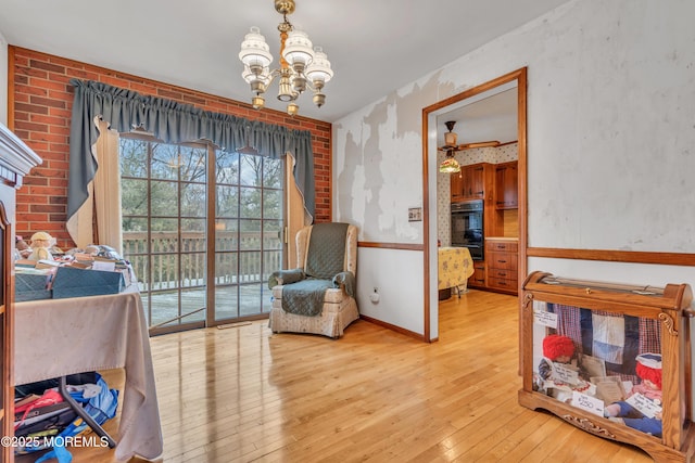 living area featuring a notable chandelier and light hardwood / wood-style floors