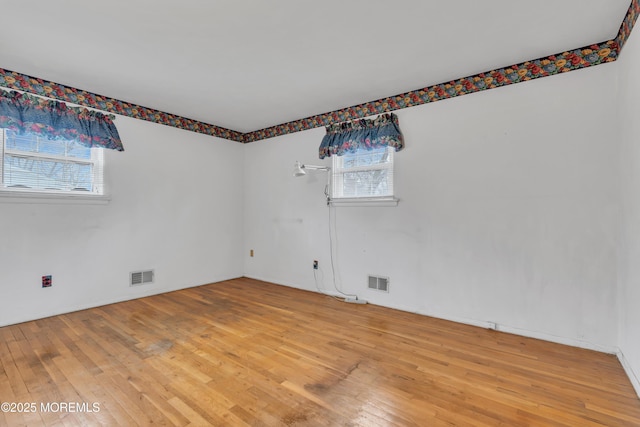 empty room with hardwood / wood-style flooring