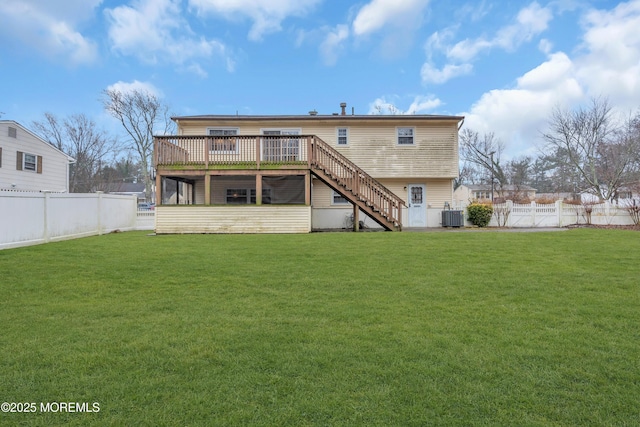 rear view of property featuring cooling unit, a deck, and a lawn