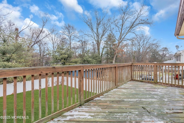 wooden terrace featuring a yard