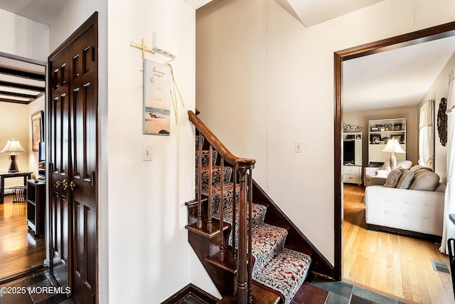 stairs with wood-type flooring