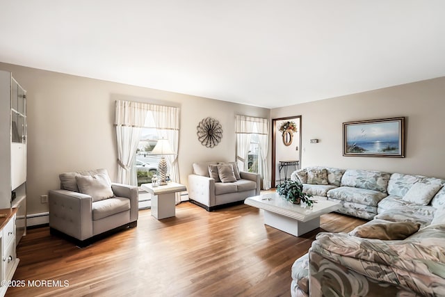 living room featuring wood-type flooring and a baseboard heating unit