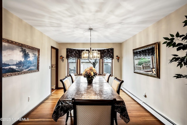 dining space featuring a notable chandelier, light hardwood / wood-style flooring, and a baseboard radiator