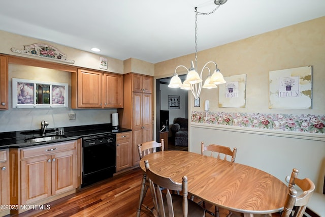 kitchen featuring a chandelier, sink, dishwasher, dark hardwood / wood-style flooring, and hanging light fixtures