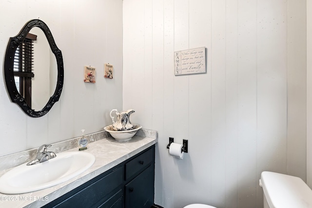 bathroom featuring toilet and vanity