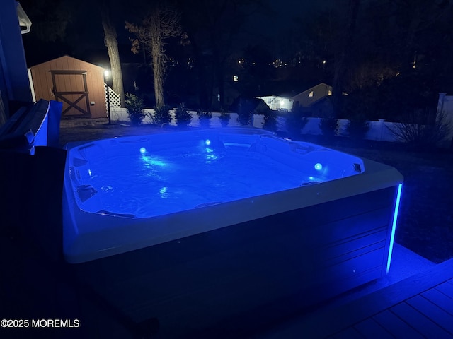 pool at night with a storage shed