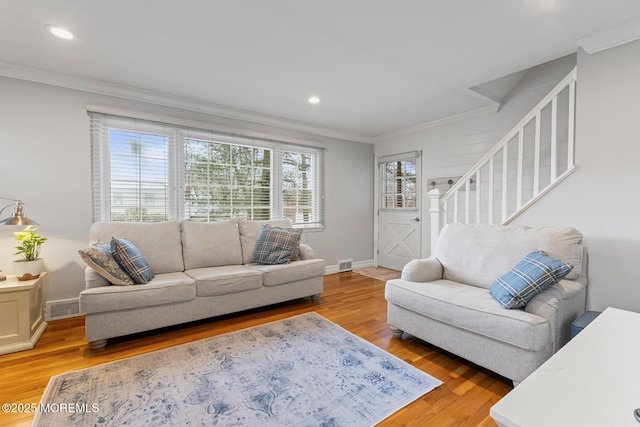 living room with hardwood / wood-style floors and crown molding