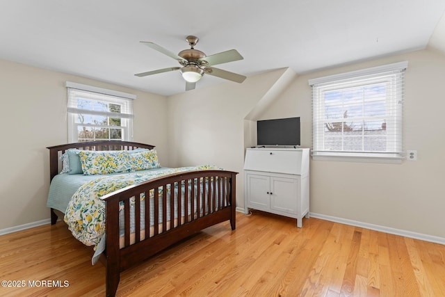 bedroom with vaulted ceiling, ceiling fan, and light wood-type flooring