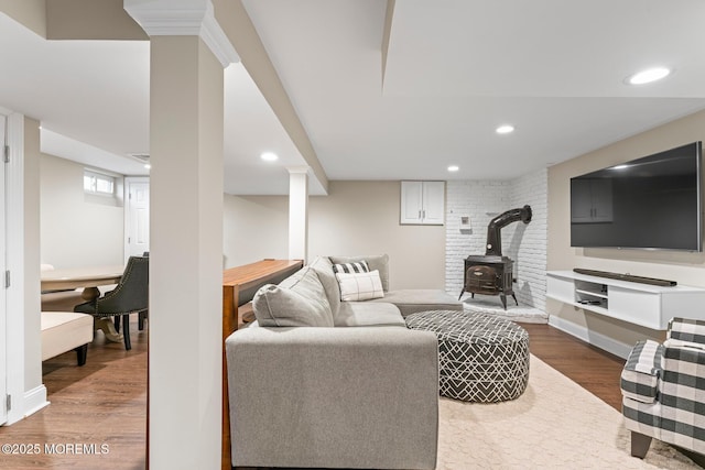 living room featuring hardwood / wood-style flooring and a wood stove