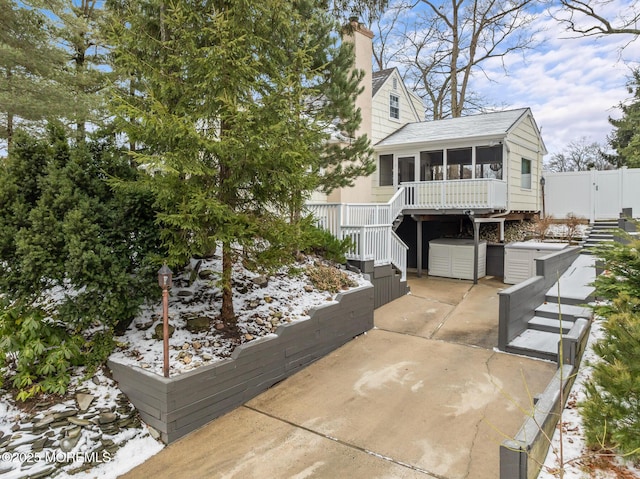 view of front of house with a patio and a sunroom