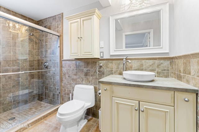 bathroom featuring walk in shower, toilet, tile walls, vanity, and tile patterned flooring