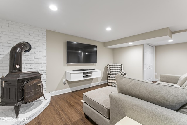 living room with dark hardwood / wood-style floors and a wood stove