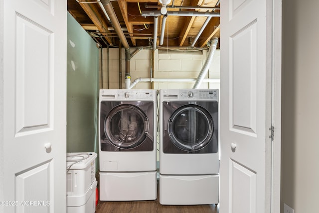 washroom featuring separate washer and dryer and dark hardwood / wood-style flooring