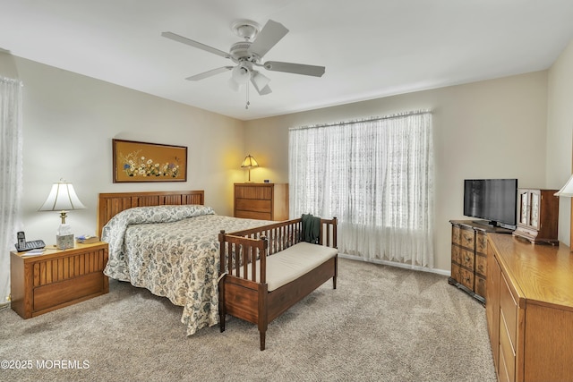 bedroom featuring ceiling fan and light carpet