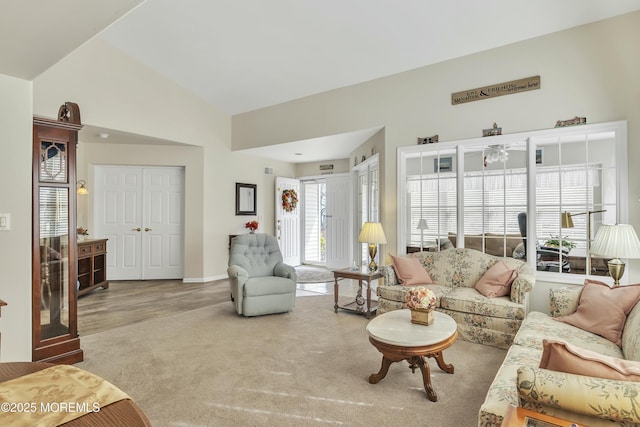 living room with lofted ceiling and carpet flooring