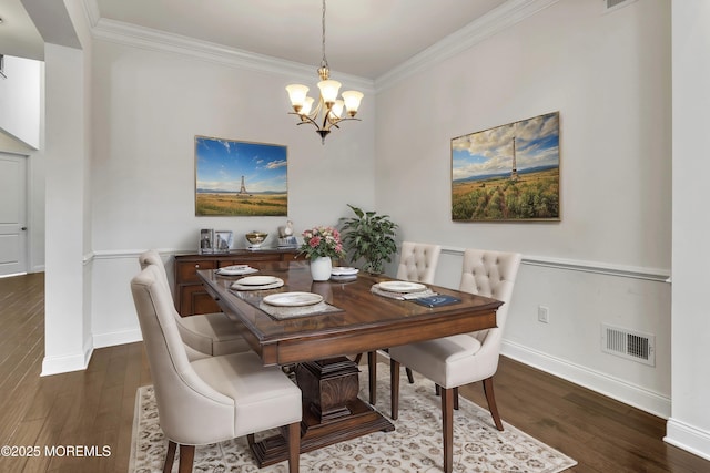 dining space featuring ornamental molding, dark hardwood / wood-style flooring, and a chandelier