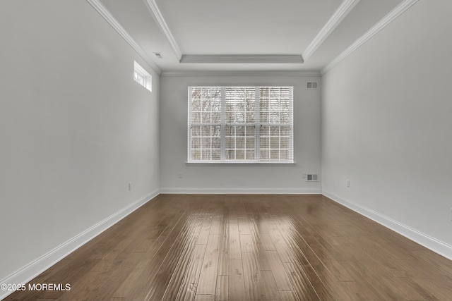 spare room featuring hardwood / wood-style flooring, crown molding, and a tray ceiling