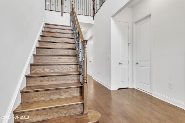 stairway with hardwood / wood-style flooring