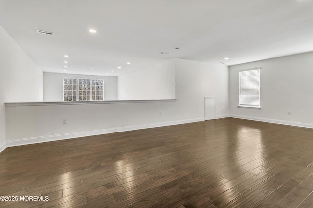 empty room with dark hardwood / wood-style flooring