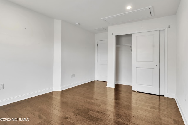 unfurnished bedroom featuring hardwood / wood-style flooring and a closet