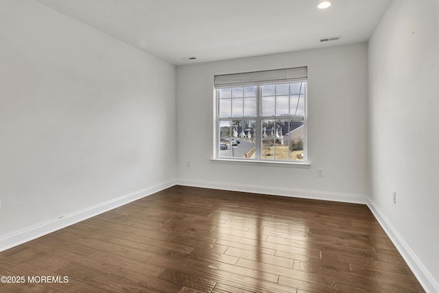 empty room with dark wood-type flooring