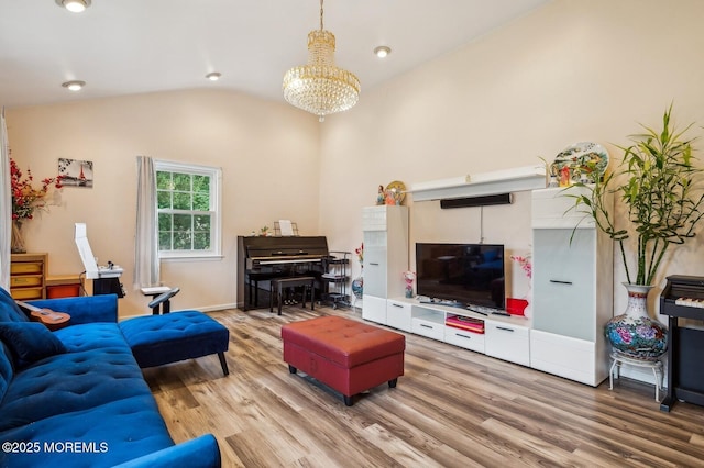 living room with hardwood / wood-style flooring, lofted ceiling, and an inviting chandelier