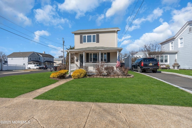 front of property with covered porch and a front lawn