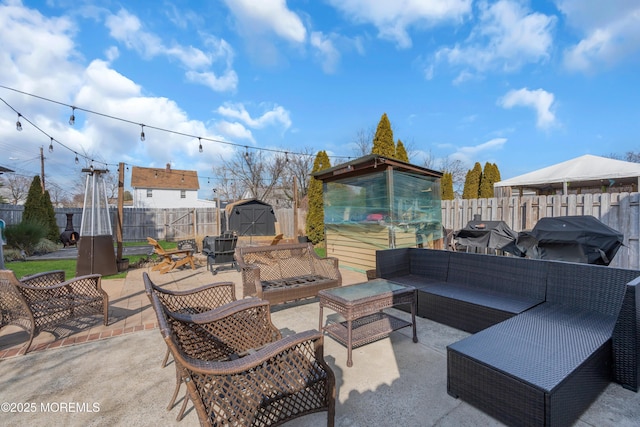 view of patio / terrace featuring area for grilling, outdoor lounge area, and a storage unit