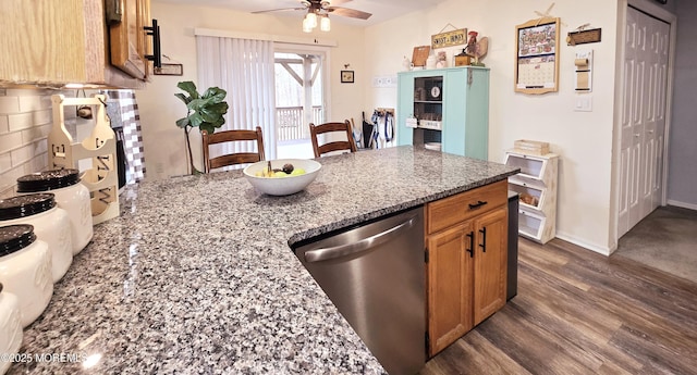 kitchen featuring dishwasher, dark hardwood / wood-style floors, ceiling fan, and stone countertops